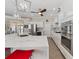 Bright kitchen with stainless steel appliances, a wine cooler, white cabinets, a large island and pendant lighting at 2479 Sonoma Dr W, Nokomis, FL 34275