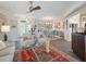 Open-concept living room featuring tile flooring, a view of the dining area, and abundant natural light at 2479 Sonoma Dr W, Nokomis, FL 34275