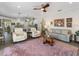 Open concept living room with modern furniture, a large area rug, and an adjacent kitchen area at 2479 Sonoma Dr W, Nokomis, FL 34275