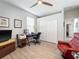 Well-lit home office with hardwood floors, a desk setup, and a closet for storage at 2479 Sonoma Dr W, Nokomis, FL 34275