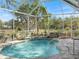 Inviting screened pool area with a waterfall feature and lush landscaping creates a private, relaxing outdoor oasis at 2479 Sonoma Dr W, Nokomis, FL 34275