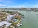 Stunning aerial view of a modern waterfront home with pool, dock, and bay views at 36 Dolphin Dr, Treasure Island, FL 33706