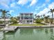 Expansive aerial view of the modern home and dock, situated on waterfront property at 36 Dolphin Dr, Treasure Island, FL 33706