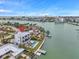 Aerial view featuring modern waterfront home, private pool, boat dock, and red pin marker at 36 Dolphin Dr, Treasure Island, FL 33706