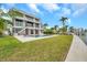 Expansive backyard with a sparkling pool, lush lawn, and a private dock for waterfront living at 36 Dolphin Dr, Treasure Island, FL 33706