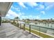 A large balcony overlooking the water, with modern railings and tile floors at 36 Dolphin Dr, Treasure Island, FL 33706