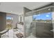 Bright bathroom boasts a glass shower, soaking tub, and large window with beautiful outdoor views at 36 Dolphin Dr, Treasure Island, FL 33706