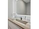 Stylish bathroom with a lighted mirror, modern faucet, and elegant counter, creating a spa-like atmosphere at 36 Dolphin Dr, Treasure Island, FL 33706