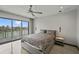 Bright bedroom with waterfront view through sliding glass doors to a balcony at 36 Dolphin Dr, Treasure Island, FL 33706