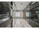 Walk-in closet featuring glass-front cabinets and marble floors at 36 Dolphin Dr, Treasure Island, FL 33706