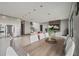 Open floor plan with a dining area featuring a wooden table, modern white chairs, and views of the living space at 36 Dolphin Dr, Treasure Island, FL 33706