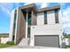 Modern home exterior with a gray color scheme, staircase, and a garage at 36 Dolphin Dr, Treasure Island, FL 33706
