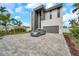 Striking contemporary two-story home with modern architectural features, a gray brick driveway, and a silver car at 36 Dolphin Dr, Treasure Island, FL 33706