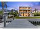 Stunning waterfront home with a private dock, swimming pool, and lush tropical landscaping at 36 Dolphin Dr, Treasure Island, FL 33706