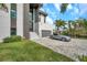 Contemporary home with a modern entryway, featuring a gray brick driveway, stairs, and a luxury car at 36 Dolphin Dr, Treasure Island, FL 33706