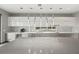 Sophisticated kitchen showcasing modern gray and white cabinetry, pendant lighting, and stainless steel appliances at 36 Dolphin Dr, Treasure Island, FL 33706