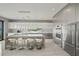 Stunning kitchen with modern appliances, large island, and sleek white cabinetry in an open-concept design at 36 Dolphin Dr, Treasure Island, FL 33706