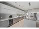 Modern kitchen featuring elegant gray and white cabinetry, stainless steel appliances, and an oversized kitchen island at 36 Dolphin Dr, Treasure Island, FL 33706