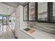 Chic kitchen wet bar with modern cabinetry, stylish hardware, a wine fridge, and marble countertops at 36 Dolphin Dr, Treasure Island, FL 33706