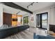 Modern living room features sleek furniture, a bright orange accent wall, and doors leading to the pool at 36 Dolphin Dr, Treasure Island, FL 33706