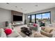 Elegant living room with a decorative fireplace, plush sofas, and scenic waterfront views from large windows at 36 Dolphin Dr, Treasure Island, FL 33706