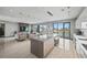 Spacious open-concept living area with modern furniture, a well-equipped kitchen, and waterfront views through large windows at 36 Dolphin Dr, Treasure Island, FL 33706