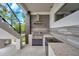 Outdoor kitchen with stainless steel grill, modern cabinetry, and beautiful countertops, perfect for entertaining at 36 Dolphin Dr, Treasure Island, FL 33706