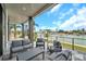 Inviting outdoor patio with modern furniture and panoramic water views for relaxation and entertainment at 36 Dolphin Dr, Treasure Island, FL 33706
