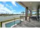 Spacious outdoor patio overlooking a sleek pool and stunning waterfront, perfect for entertaining and relaxation at 36 Dolphin Dr, Treasure Island, FL 33706