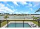 Backyard pool with waterfront view, deck and lounge seating at 36 Dolphin Dr, Treasure Island, FL 33706