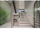 The contemporary staircase with wooden steps and a modern railing leads to the upper levels of the home at 36 Dolphin Dr, Treasure Island, FL 33706