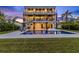 Beautiful backyard pool with lounge chairs and well-manicured lawn creates the perfect outdoor retreat at 36 Dolphin Dr, Treasure Island, FL 33706