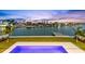 Panoramic water view from the pool deck with lush green lawn at 36 Dolphin Dr, Treasure Island, FL 33706