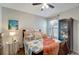 Bedroom features a queen bed with coastal themed bedding, ceiling fan and cabinet at 3720 Pebble Ter, Punta Gorda, FL 33980