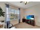 Bedroom with a window and a ceiling fan plus a TV and cabinet at 3720 Pebble Ter, Punta Gorda, FL 33980