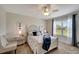 Serene bedroom with a coastal theme, featuring a decorative headboard and sheer curtains at 3720 Pebble Ter, Punta Gorda, FL 33980