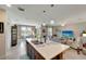 Open-concept kitchen with island, leading into dining and living areas at 3720 Pebble Ter, Punta Gorda, FL 33980