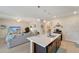 Bright kitchen featuring a large island, pendant lights, and an adjoining living space at 3720 Pebble Ter, Punta Gorda, FL 33980