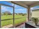 View from screened lanai to a large backyard with mature landscaping and adjacent properties at 3720 Pebble Ter, Punta Gorda, FL 33980