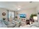 Comfortable living room with a ceiling fan, large window, and contemporary furnishings at 3720 Pebble Ter, Punta Gorda, FL 33980