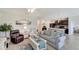 Open living room with a view into the kitchen with a breakfast bar and modern appliances at 3720 Pebble Ter, Punta Gorda, FL 33980