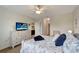 Spacious main bedroom with a ceiling fan, TV, and ensuite bathroom access at 3720 Pebble Ter, Punta Gorda, FL 33980