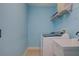 Laundry room featuring a washing machine, utility sink and wire shelving at 435 Manns Harbor Dr, Apollo Beach, FL 33572
