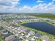 An aerial view of a neighborhood's beautiful houses situated around lakes and green spaces at 43554 Treadway Dr, Punta Gorda, FL 33982