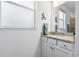 Bathroom vanity with granite countertop, double sinks, and ample lighting, offering a clean and functional design at 43554 Treadway Dr, Punta Gorda, FL 33982