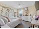 Bright bedroom features a comfortable bed, a ceiling fan, a work desk and a floral decor at 43554 Treadway Dr, Punta Gorda, FL 33982