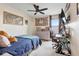 Bedroom featuring a comfortable bed, a ceiling fan, and an organized desk and media center at 43554 Treadway Dr, Punta Gorda, FL 33982