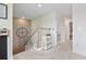 Spacious hallway featuring a stone accent wall, staircase, and white trim at 43554 Treadway Dr, Punta Gorda, FL 33982