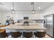 Bright kitchen with white cabinets, granite countertops, stainless steel appliances, and an island with seating at 43554 Treadway Dr, Punta Gorda, FL 33982