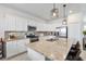 Modern kitchen featuring white cabinetry, granite countertops, and stainless steel appliances at 43554 Treadway Dr, Punta Gorda, FL 33982